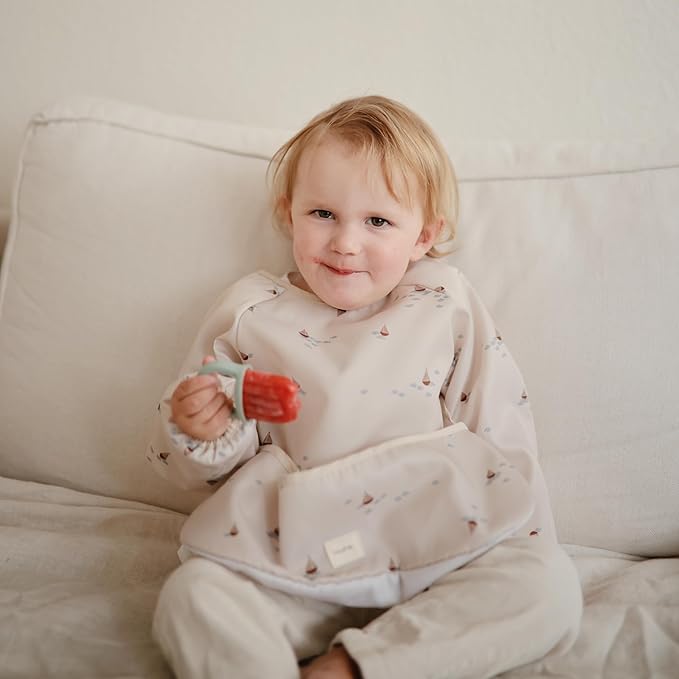 mushie Long Sleeve Baby Bib | Water Resistant Adjustable Fit for Ages 6-24 Months