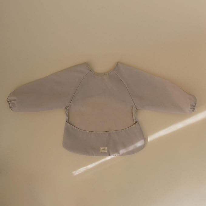 mushie Long Sleeve Baby Bib | Water Resistant Adjustable Fit for Ages 6-24 Months